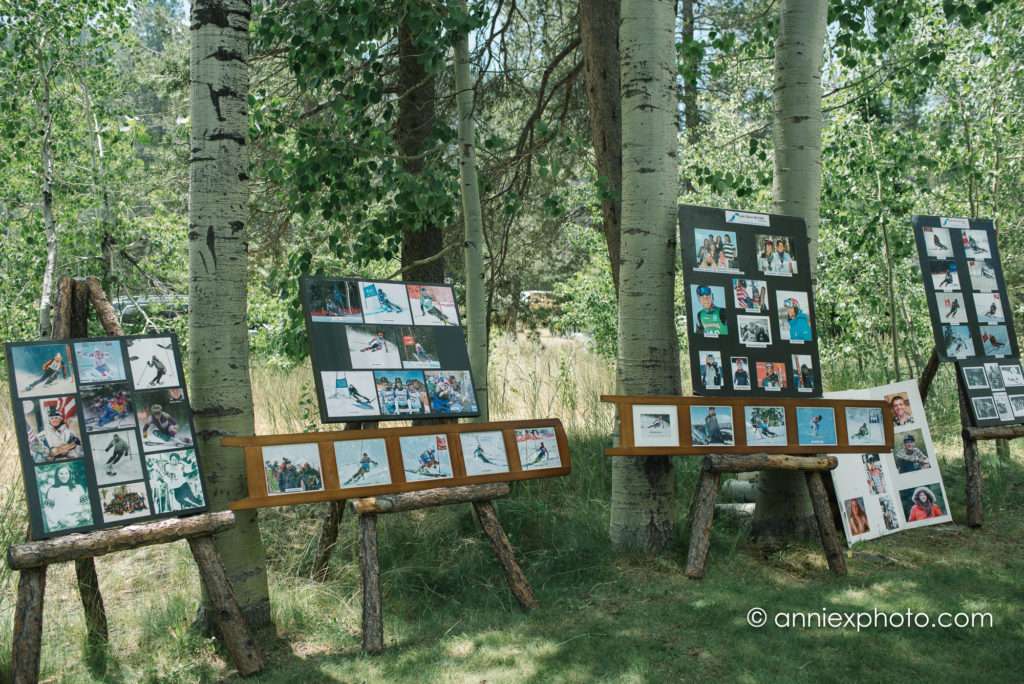 Photos of youth skiers on a display outdoors