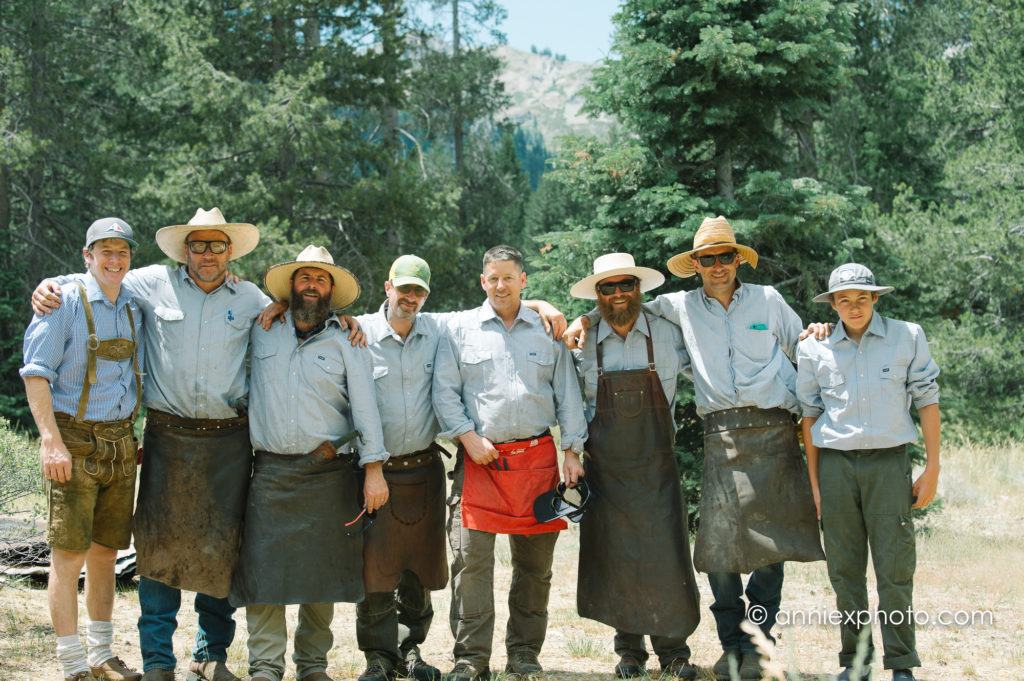 Men in aprons standing in a row